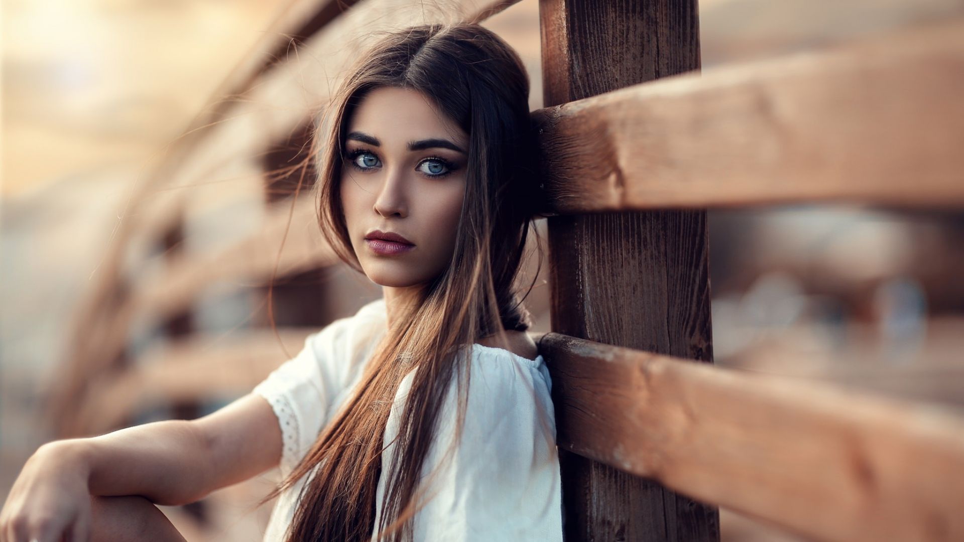 Wallpaper Beautiful girl sitting, leaning to wooden fence