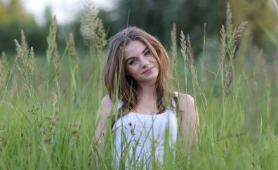 Smiling face of girl, grassland