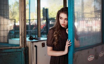 Girl model, brunette, leaning to door