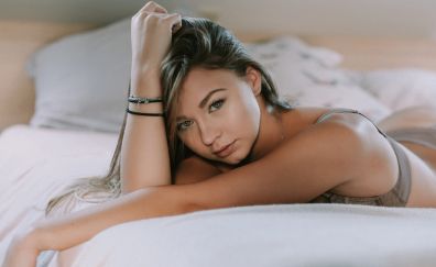 Girl model, lying on bed, brunette