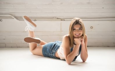 Cute, smiling girl, laying on front floor