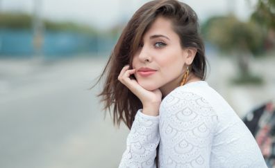 Brunette woman, hand on face