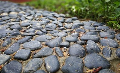 Black pebbles on way, rocks
