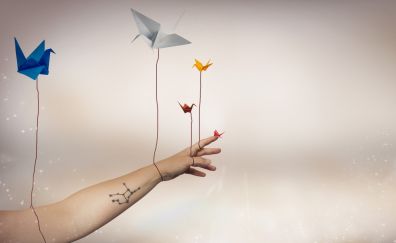 Digital artwork of paper birds on hand