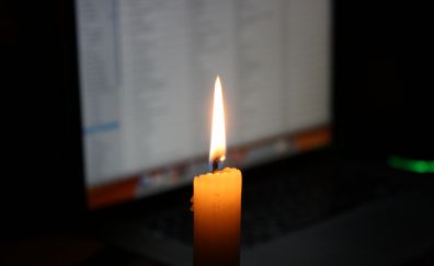 Candle flame, lights, laptop screen