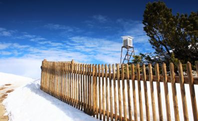 Wooden fence, snow, mountains
