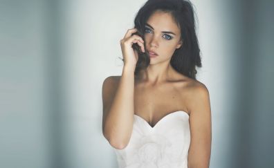 Brunette model in white dress